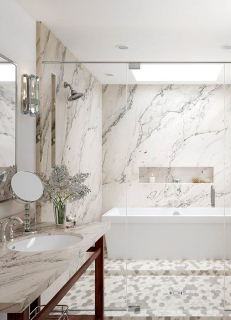 marble attache calacatta hex mosaic flooring by Daltile in bathroom with marble shower and bathtub.